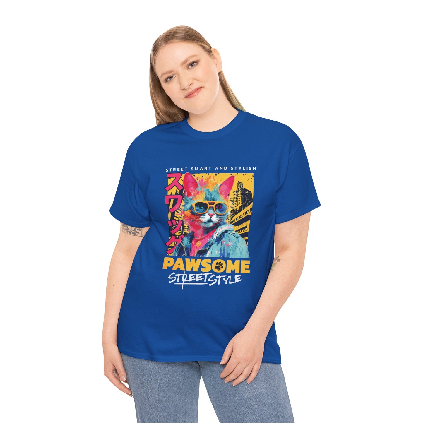 Person wearing a blue t-shirt with a colorful cat graphic and text on a white background