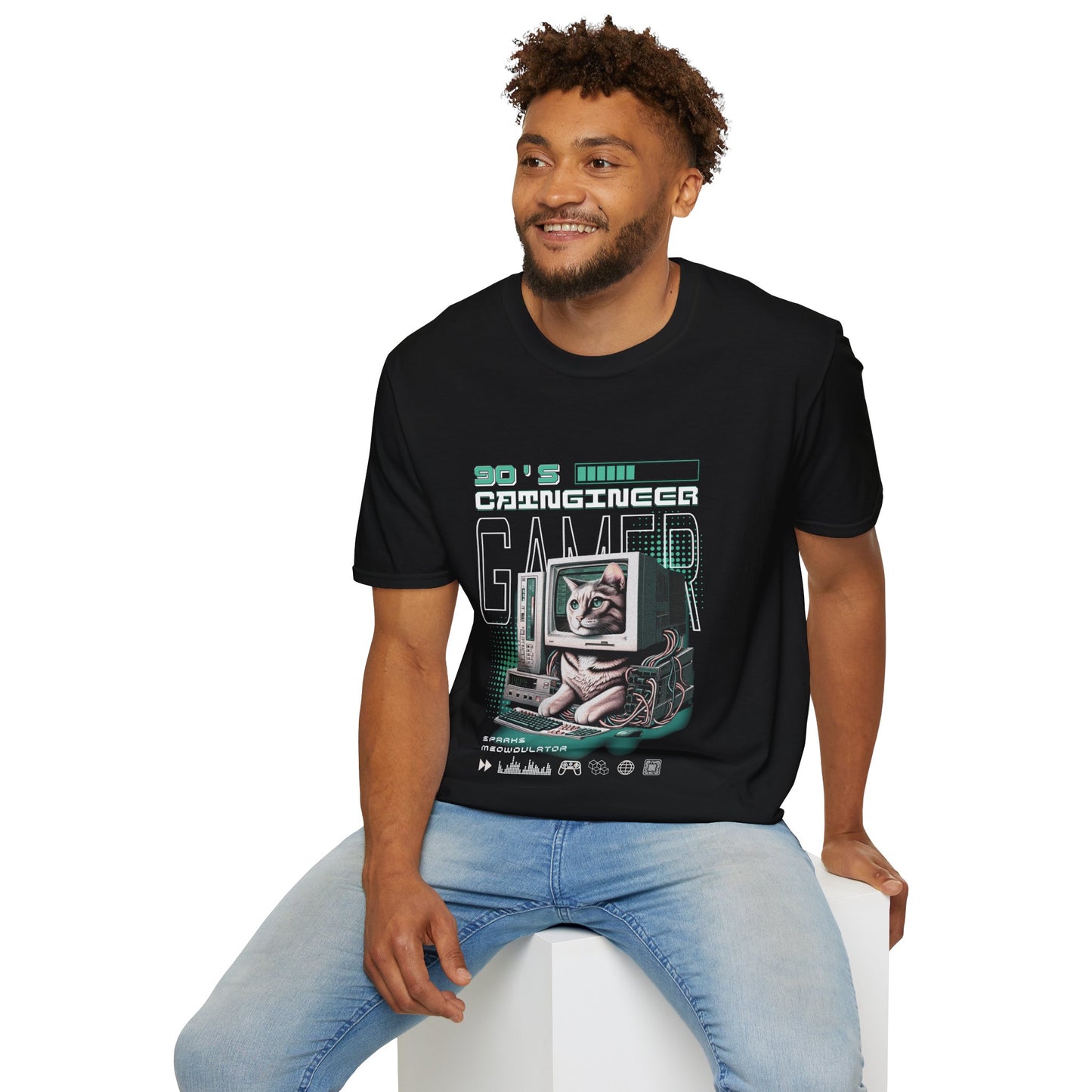 Man wearing a black t-shirt with a graphic design sitting on a white stool against a white background