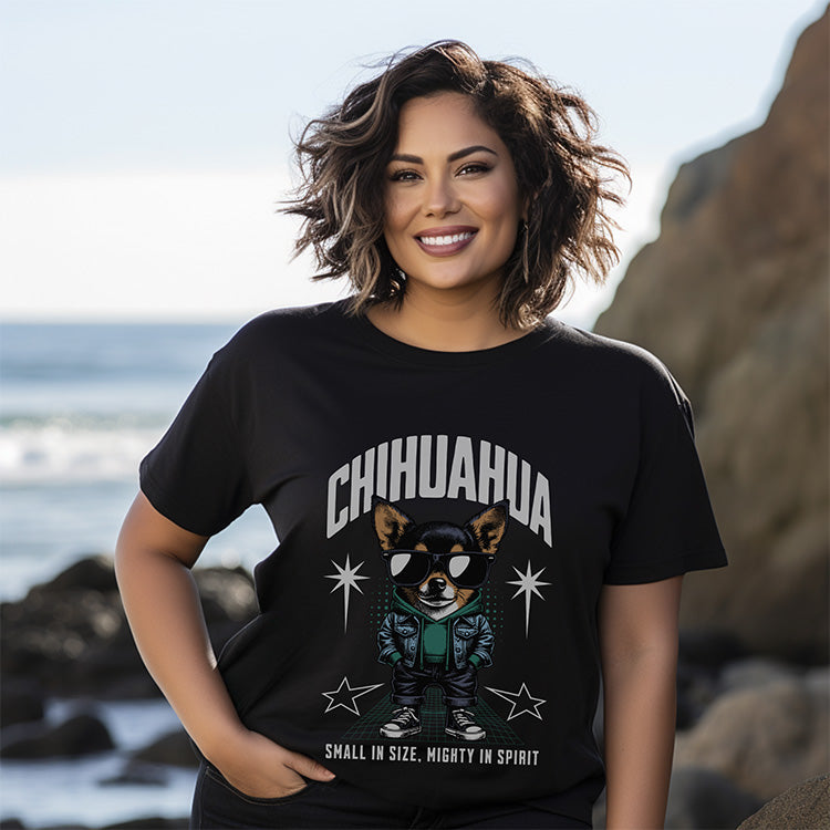 Woman wearing a black t-shirt with a chihuahua graphic and text on a beach.