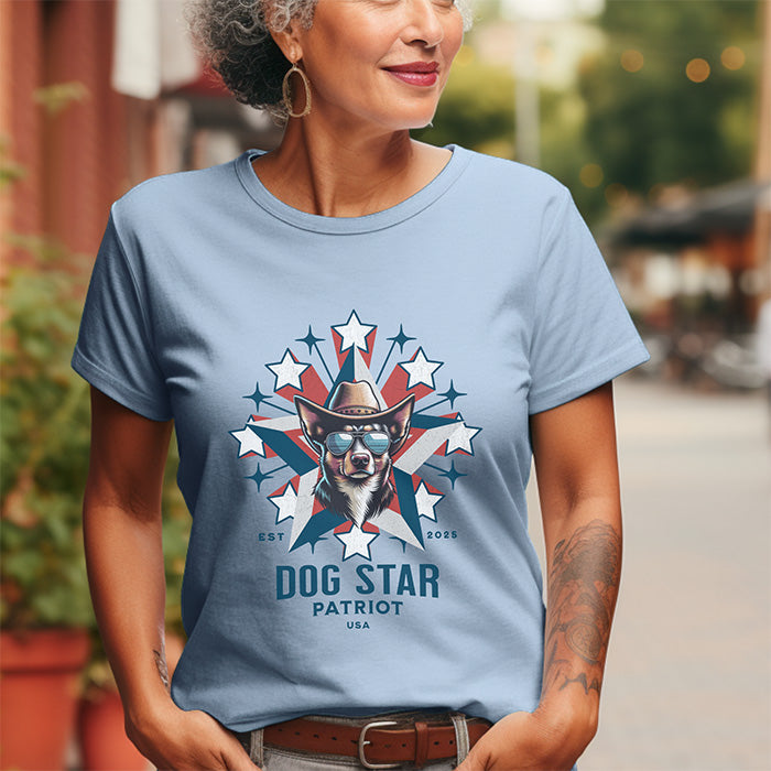 Woman wearing a light blue t-shirt with a graphic design of a dog in a cowboy hat and sunglasses, surrounded by stars and the text 'Dog Star Patriot USA'.
