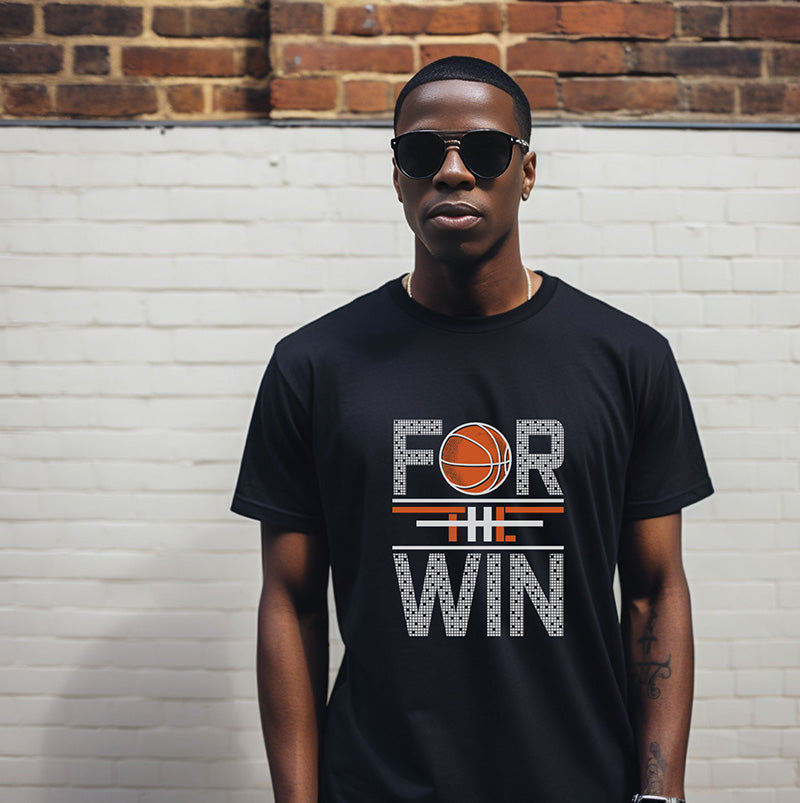 Man wearing a black t-shirt with 'For the Win' design against a brick wall.