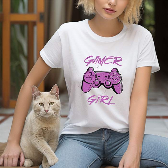 Person wearing a white t-shirt with 'Gamer Girl' design sitting next to a cat.