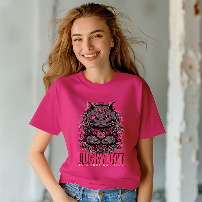 Person wearing a pink t-shirt with a cat graphic and text, standing against a neutral background.