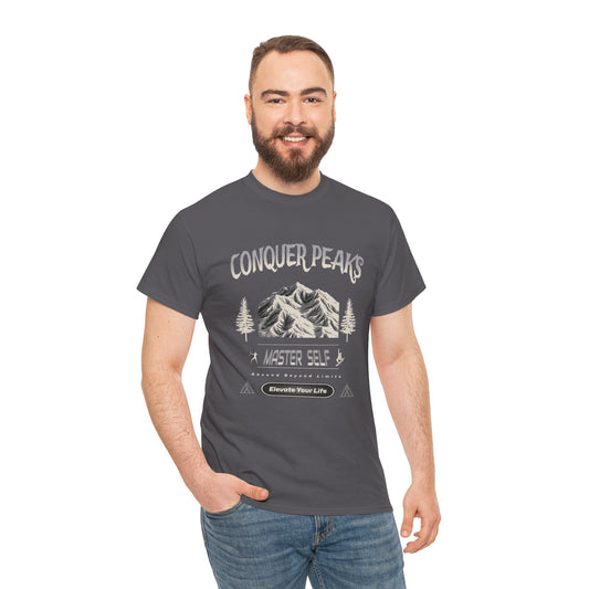 Man wearing a t-shirt with 'Conquer Peaks' graphic design on a white background
