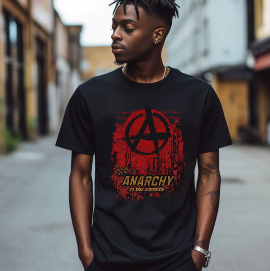 Person wearing a black t-shirt with a red and yellow 'Anarchy' graphic design on a street.