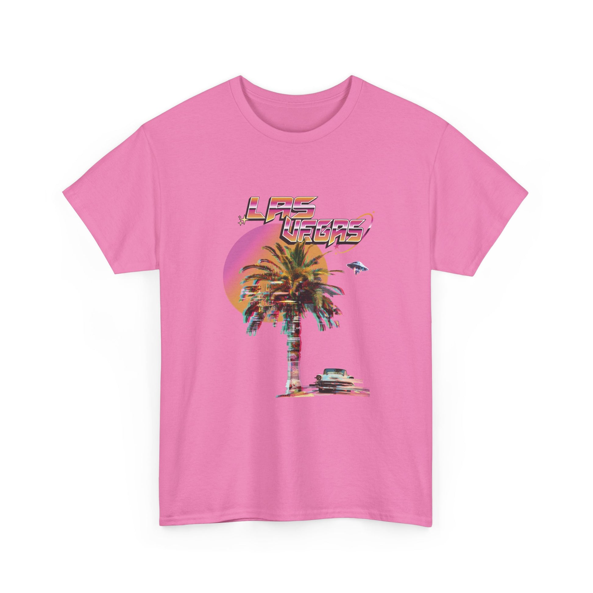 A flamingo pink t-shirt with a retro Las Vegas glitch graphic featuring a palm tree, a sunset, and UFOs over a desert landscape.