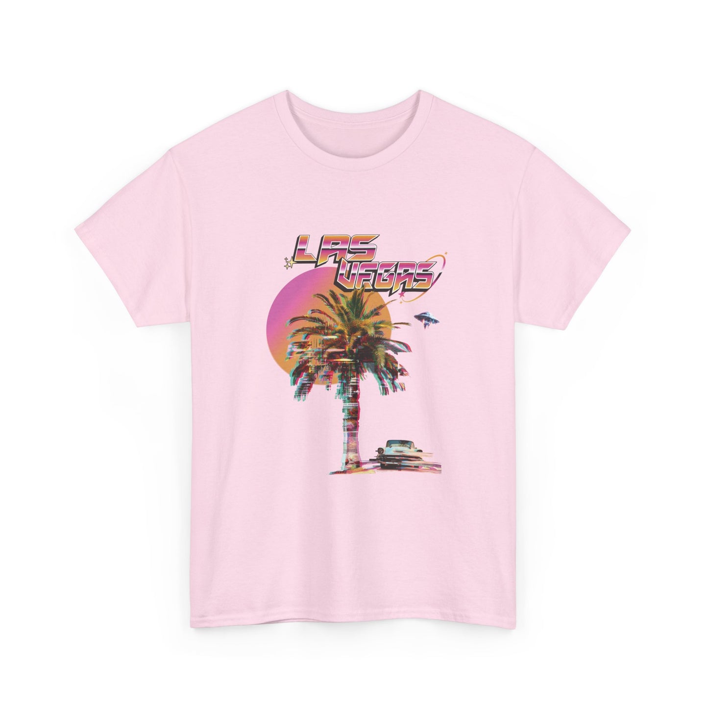 A light pink t-shirt with a retro Las Vegas glitch graphic featuring a palm tree, a sunset, and UFOs over a desert landscape.