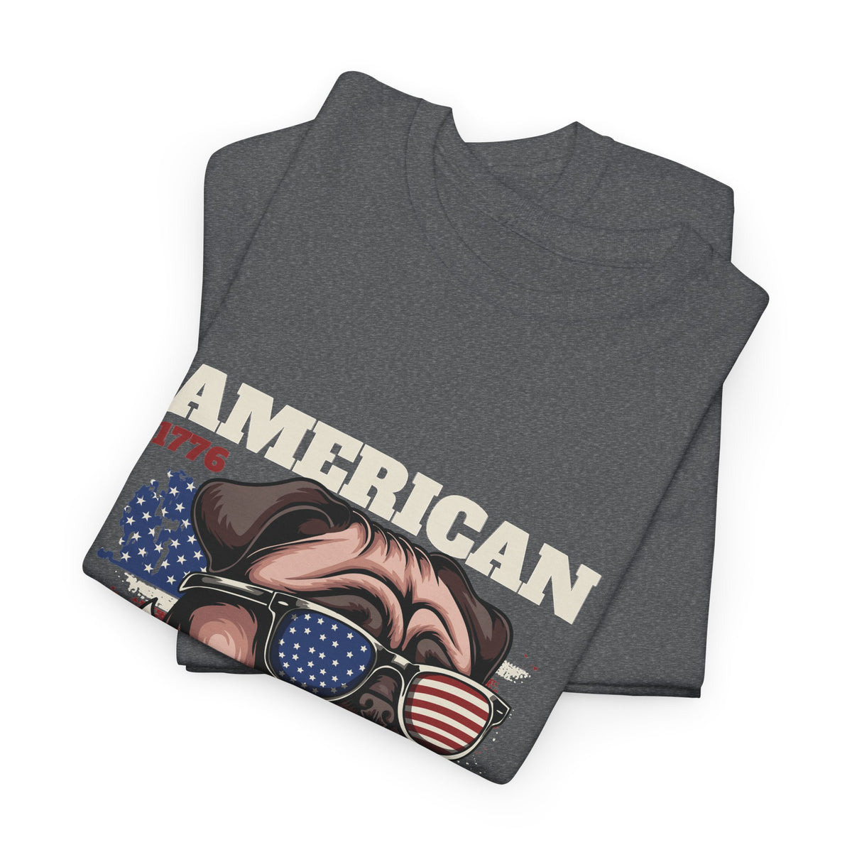 A folded heather gray t-shirt featuring a graphic print of a pug dog wearing sunglasses with an American flag pattern, with the text 'AMERICAN' in white and '1776' in red.