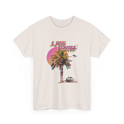 A light gray t-shirt with a retro Las Vegas glitch graphic featuring a palm tree, a sunset, and UFOs over a desert landscape.