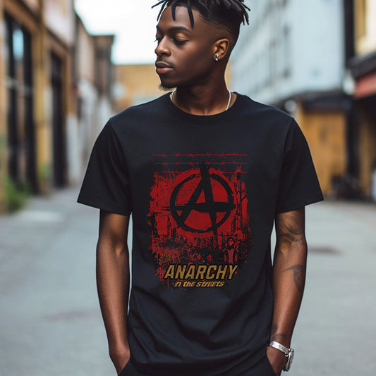 Person wearing a black t-shirt with a red and yellow 'Anarchy in the Streets' design on a street.