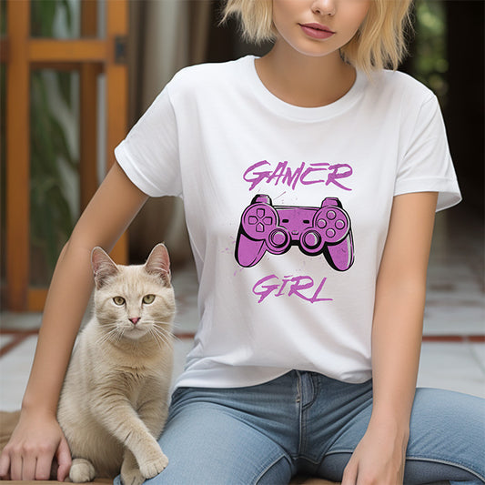 Person wearing a white t-shirt with 'Gamer Girl' design sitting next to a cat.