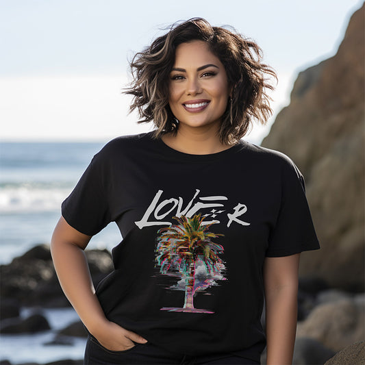 Woman wearing a black t-shirt with a colorful palm tree design and 'LOVER' text on a beach.