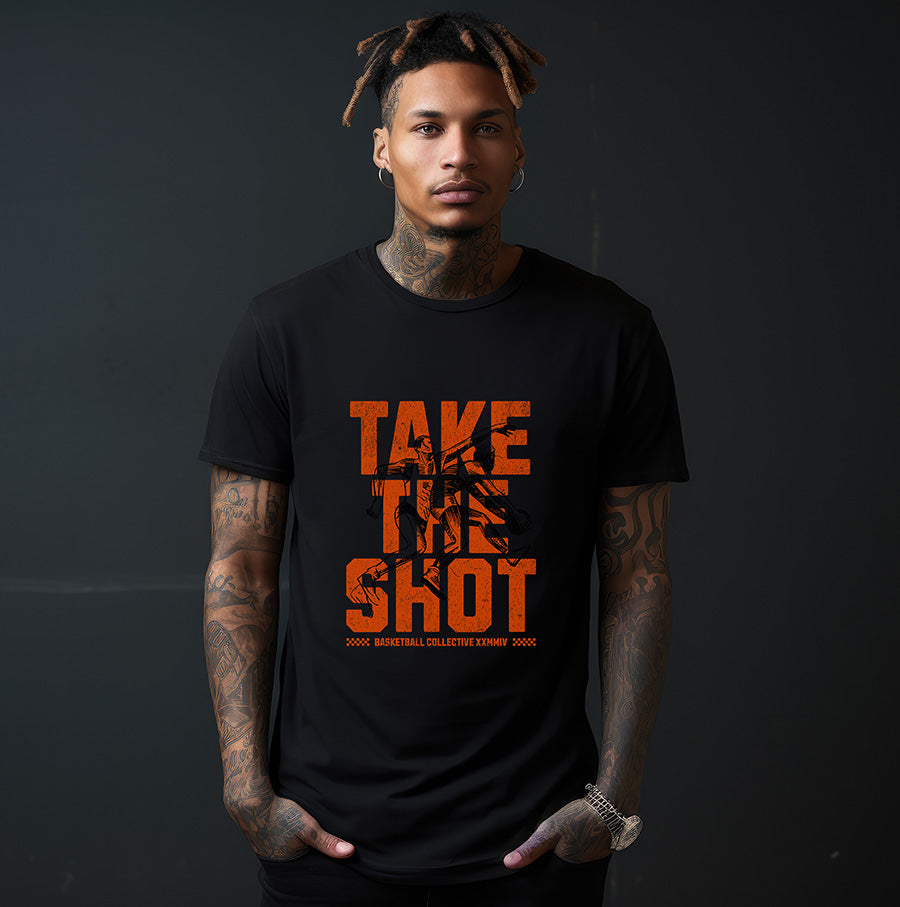 Person wearing a black t-shirt with 'TAKE THE SHOT' in orange text on a dark background