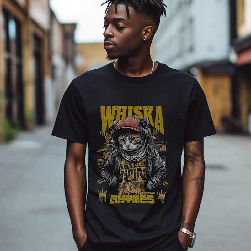A person wearing a black t-shirt featuring a hip-hop inspired cat graphic wearing a red cap and hoodie, with the bold yellow text 'Whiska Rhymes' and urban crown details.